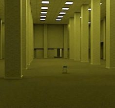 an empty room with columns and lights on the ceiling