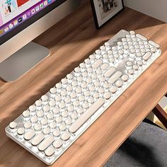 a computer keyboard sitting on top of a wooden desk