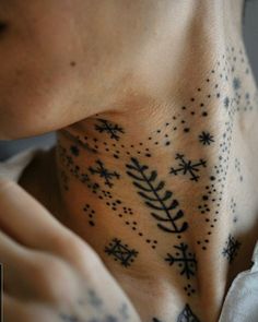 a woman with her neck covered in snowflakes and stars on the back of her neck