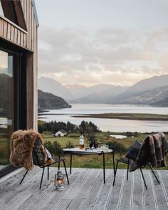 two chairs sitting on top of a wooden deck