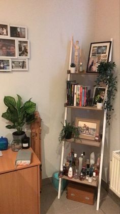 a living room filled with lots of furniture and pictures on the wall next to a book shelf