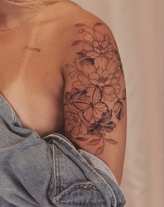 a woman with a flower tattoo on her shoulder