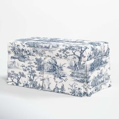 a blue and white toiler print ottoman cover sitting on top of a table