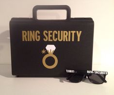 a black case with sunglasses and ring security sticker on the side next to it