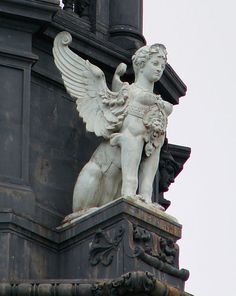 an angel statue on top of a building