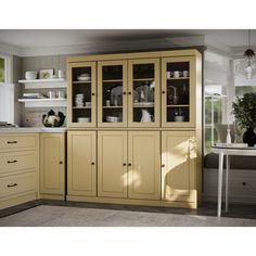 a kitchen with yellow cabinets and white walls