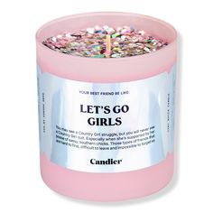 a pink candle that says let's go girls on the front and back side