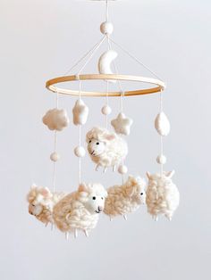 a mobile with sheep hanging from it's sides