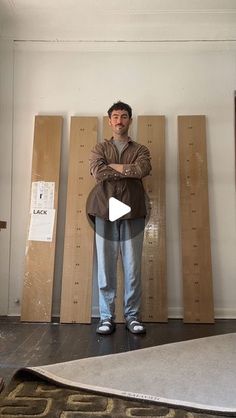 a man standing in front of some wooden boards