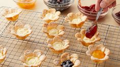 small desserts on cooling racks with jam and jelly in the bowl next to them