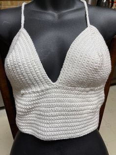 This top is made from cotton yarn.  It is a size medium. Chic Cotton V-neck Halter Top, White Knit V-neck Crop Top, White Cropped Knit Tank Top, Fitted Cropped Knit Tank Top, Fitted Crochet V-neck Crop Top, Spring Cotton Fitted Crop Top, White Knit Crop Top Tank Top, Fitted Cotton Crop Top For Spring, Casual Fitted Halter Crop Top