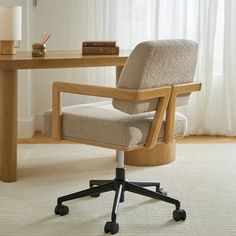 an office chair sitting on top of a rug next to a desk with a lamp