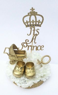 there is a cake topper that says it's prince with shoes and a baby carriage