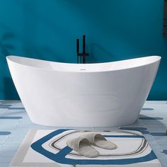 a white bath tub sitting on top of a bathroom floor next to a blue wall