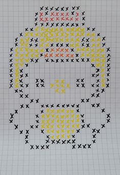 a cross - stitch pattern with yellow and black crosses on it, in the shape of a smiley face