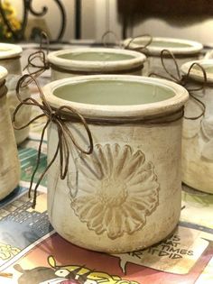 several ceramic jars are sitting on a table