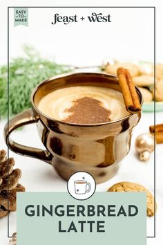 gingerbread latte in a mug with cinnamon sticks on the side, surrounded by cookies and spices