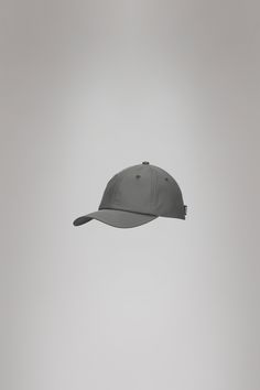 Cap is Rains' take on the classic baseball cap with 6 panels and curved brim. The Cap is characterized by a curved brim and six-paneled design held in place by a back-mounted adjustable webbing strap and buckle. It features eyelets to ensure ventilation for breathable comfort. Cap is cut from Rains' signature PU fabric. The finish is lightweight with a smooth feel. Gray Outdoor Cap, Moisture-wicking Baseball Cap For Streetwear, Streetwear Moisture-wicking Baseball Cap, Gray 5-panel Baseball Cap One Size, Gray 5-panel Baseball Cap For Outdoor, Baseball Caps, Pu Fabric, Baseball Cap, Cape