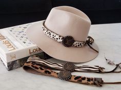 Give your hat some flair with this amazing hat band. One size fits most hats Adjustable Haircalf Approx 3/4" wide Keep it Gypsy Attention/Disclosure: This product is an upcycled product made from legally, purchased used Louis Vuitton products. It was created and designed by Keep It Gypsy, LLC. Keep It Gypsy does not sell new Louis Vuitton product used in this upcycled product does not reflect the condition of the Louis Vuitton product as it was originally sold. Keep It Gypsy is not associated wi Cowhide Projects, Customized Hats, Upcycled Product, Upcycled Louis Vuitton, Cowgirl Closet, Leopard Hat, Louis Vuitton Hat, Louie Vuitton, Hat Bands