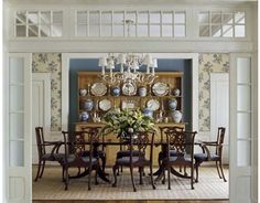 a formal dining room with blue walls and white trim