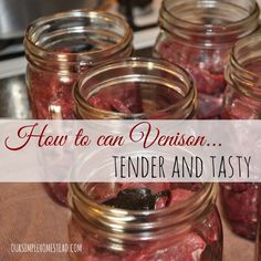 jars filled with red meat sitting on top of a table