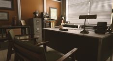 an office with two chairs and a desk in front of a window that has blinds on it