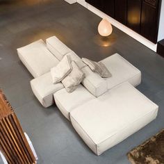 a large white couch sitting on top of a hard wood floor