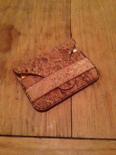 an empty wallet sitting on top of a wooden floor