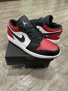 Elevate your shoe collection with these Nike Air Jordan 1 Low shoes in the iconic Bred Toe colorway. The red, black, and white leather upper embodies the classic Jordan 1 silhouette, while the cross-training, CrossFit, and running & jogging performance make them versatile for any activity. Featuring a low top shoe shaft style and size 9.5 for men, these sneakers are perfect for any sneakerhead or athlete. The colorful theme and Nike Air product line add to the appeal of these shoes, making them a must-have for any collection. Louis Vuitton Sneakers, Red Jordans, Nike Air Jordan 1 Low, Low Shoes, Black Fire, Nike Air Jordan 1, Air Jordan 1 Low, Jordan 1 Low, Cross Training