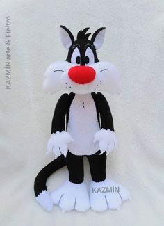 a black and white cat stuffed animal with red nose