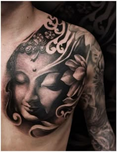 a man with a tattoo on his chest has a buddha head and flowers in it