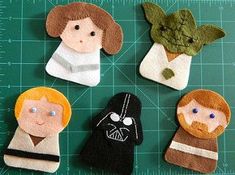 four felt star wars characters on a cutting board