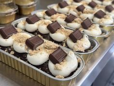 some desserts are in tins on a table