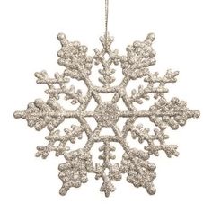 a white snowflake ornament hanging from a chain on a white background