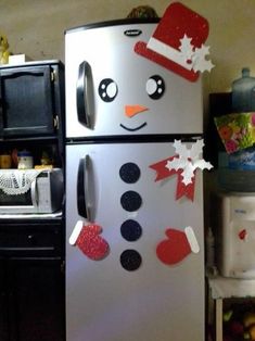 a refrigerator decorated like a snowman with red and white decorations