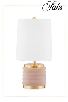 a table lamp with a white shade on it and the words faks above it