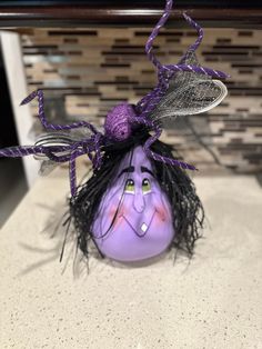 a purple spider decoration sitting on top of a counter