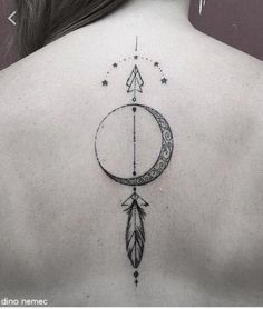 a woman's back with an arrow and crescent tattoo on her left side ribcage