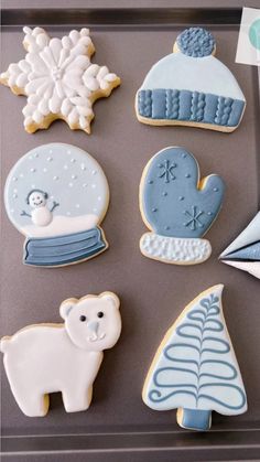 decorated cookies are displayed on a tray