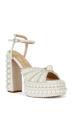 Step into luxury with the ASTRELLA sandal. Adorned with faux pearls and rhinestones, these platform heels add a touch of glamour to any outfit. The open toe silhouette and adjustable ankle strap closure provide comfort and security for all day wear. Shoes Boots Combat, White Platform Heels, Pearl Heels, White Platform Sandals, Clogs Heels, Platform Combat Boots, White Sandals Heels, Azalea Wang, Sandal Platform