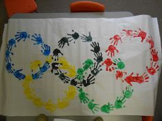 a child's handprinted table cloth with two hands in the shape of a circle