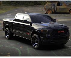 a black ram truck parked in a parking lot