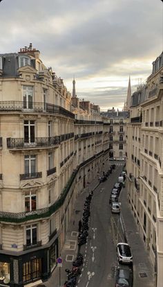 an aerial view of a city street with cars parked on both sides