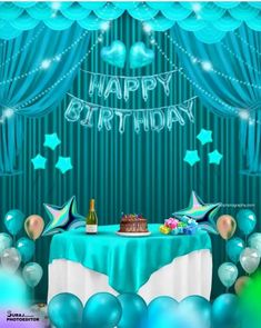 a birthday card with balloons, cake and streamers on the table in front of a curtain