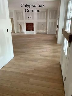 an empty room with white walls and wood floors that has been painted in the same color