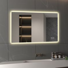 a bathroom with a sink, mirror and lights on the wall above it's counter