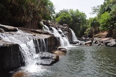 the water is running down the side of the waterfall