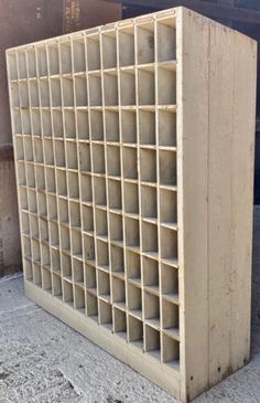 a large wooden crate sitting on top of a cement floor