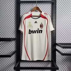 a soccer jersey hangs on a rack in the dressing room