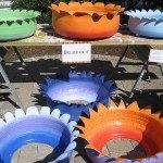 several colorful bowls are on display for sale